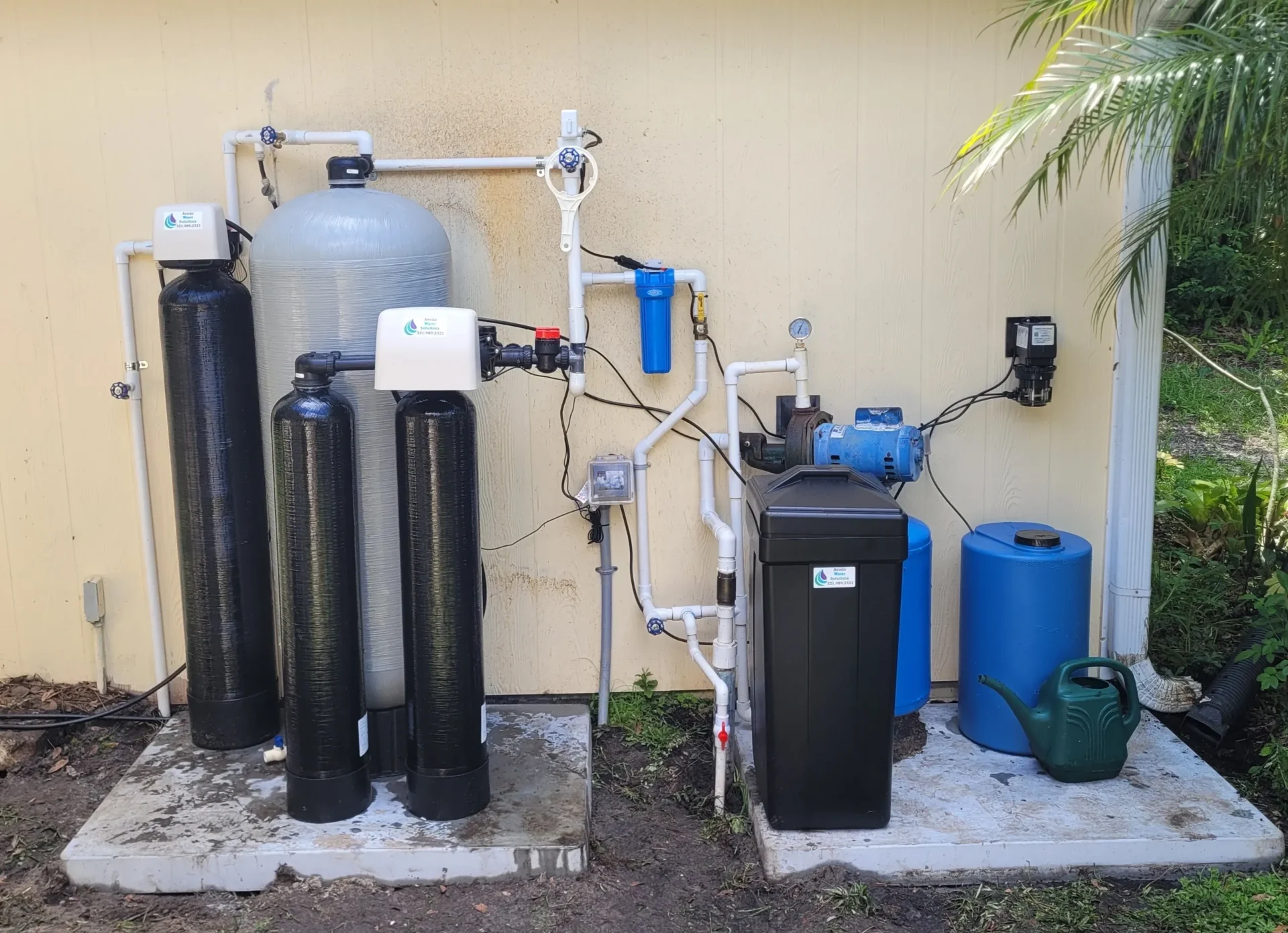 A water treatment system is shown outside of a house.